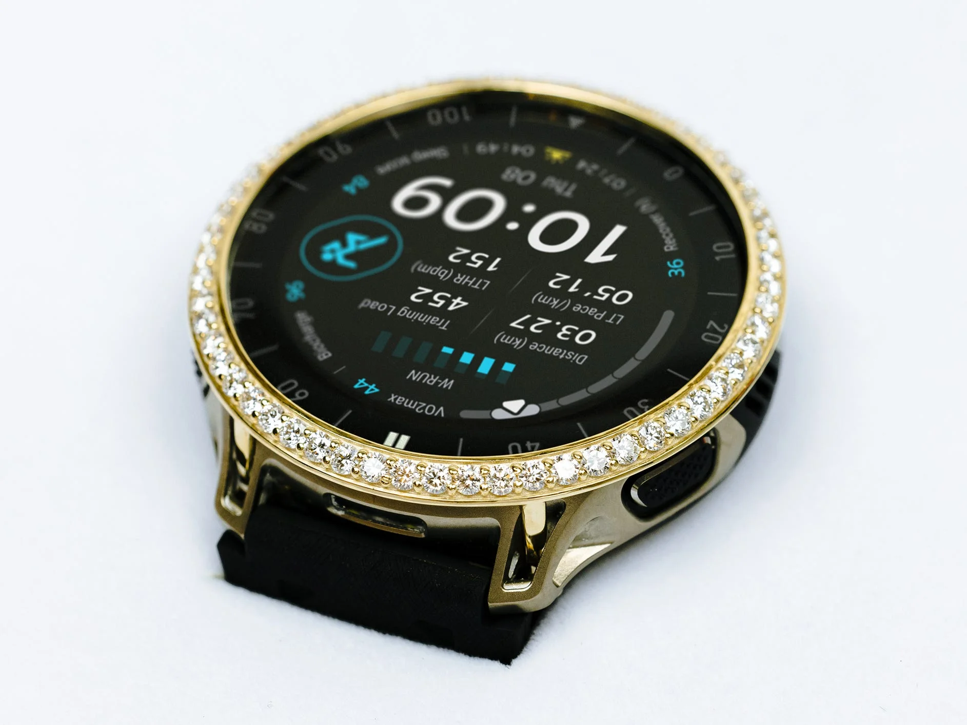 Smartwatch with a black face, gold trim, and a sparkling diamond bezel displaying various fitness metrics and time.