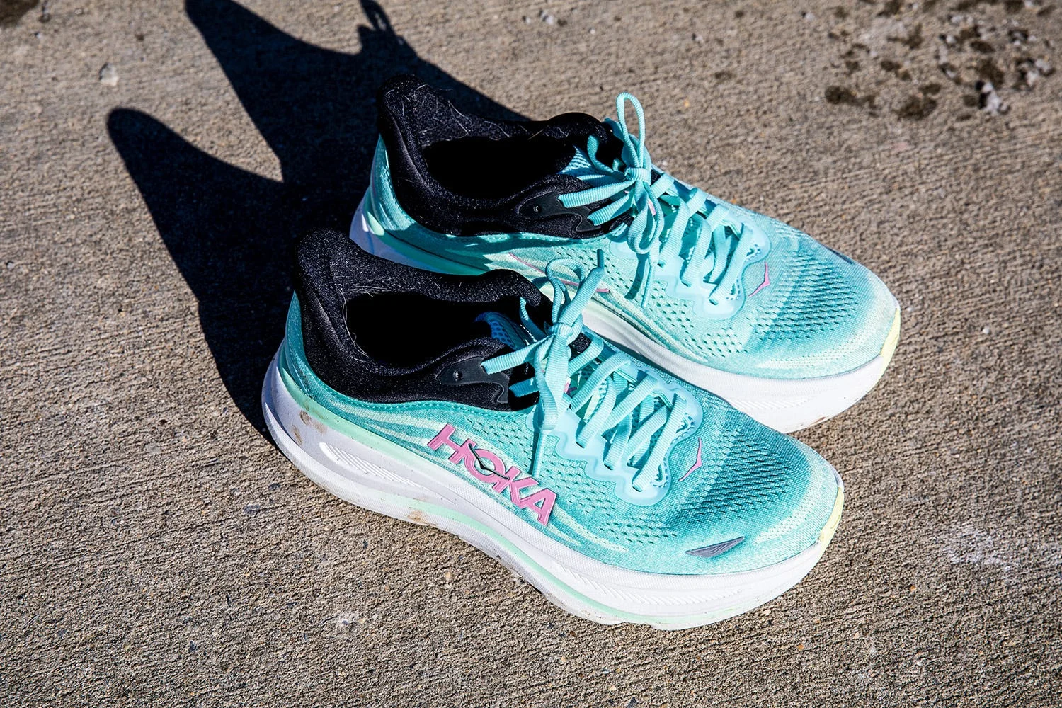 sport shoes designed for running with a light blue and black color scheme