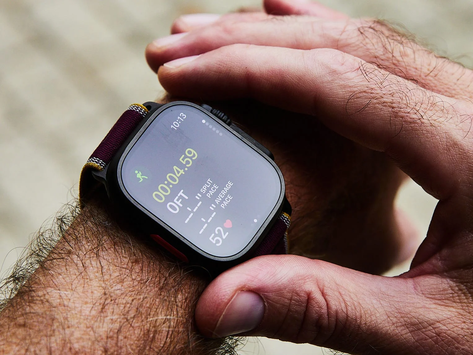 A person checking the time and activity metrics on a smartwatch worn on their wrist.