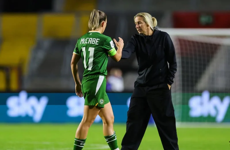 Job done: Carla Ward with Katie McCabe after tonight's win in Cork.