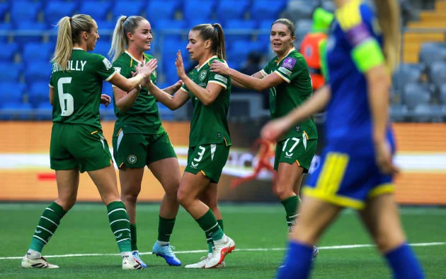 Ireland players celebrate a goal by Chloe Mustaki.
