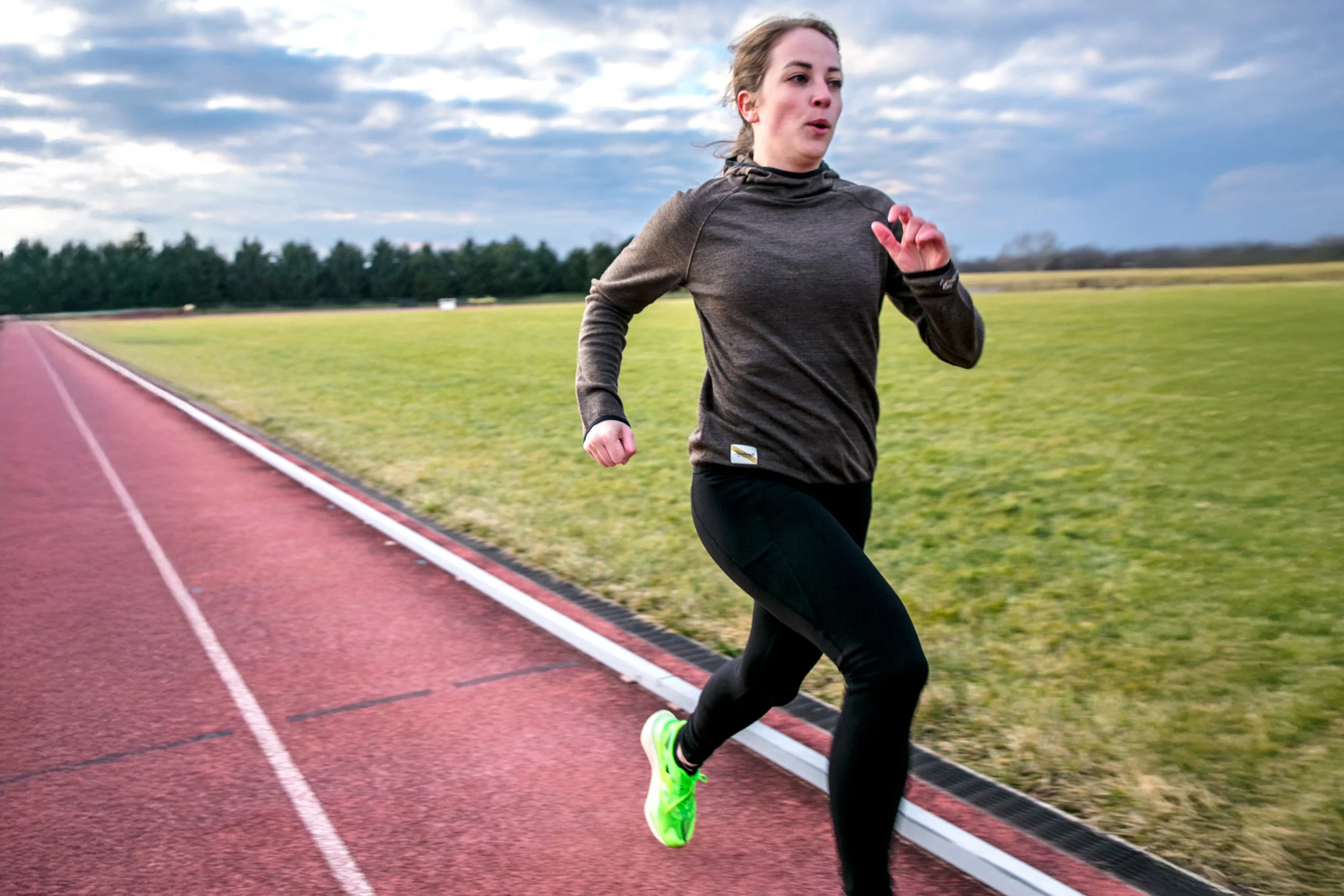 runner taking strides on track runner taking strides on track