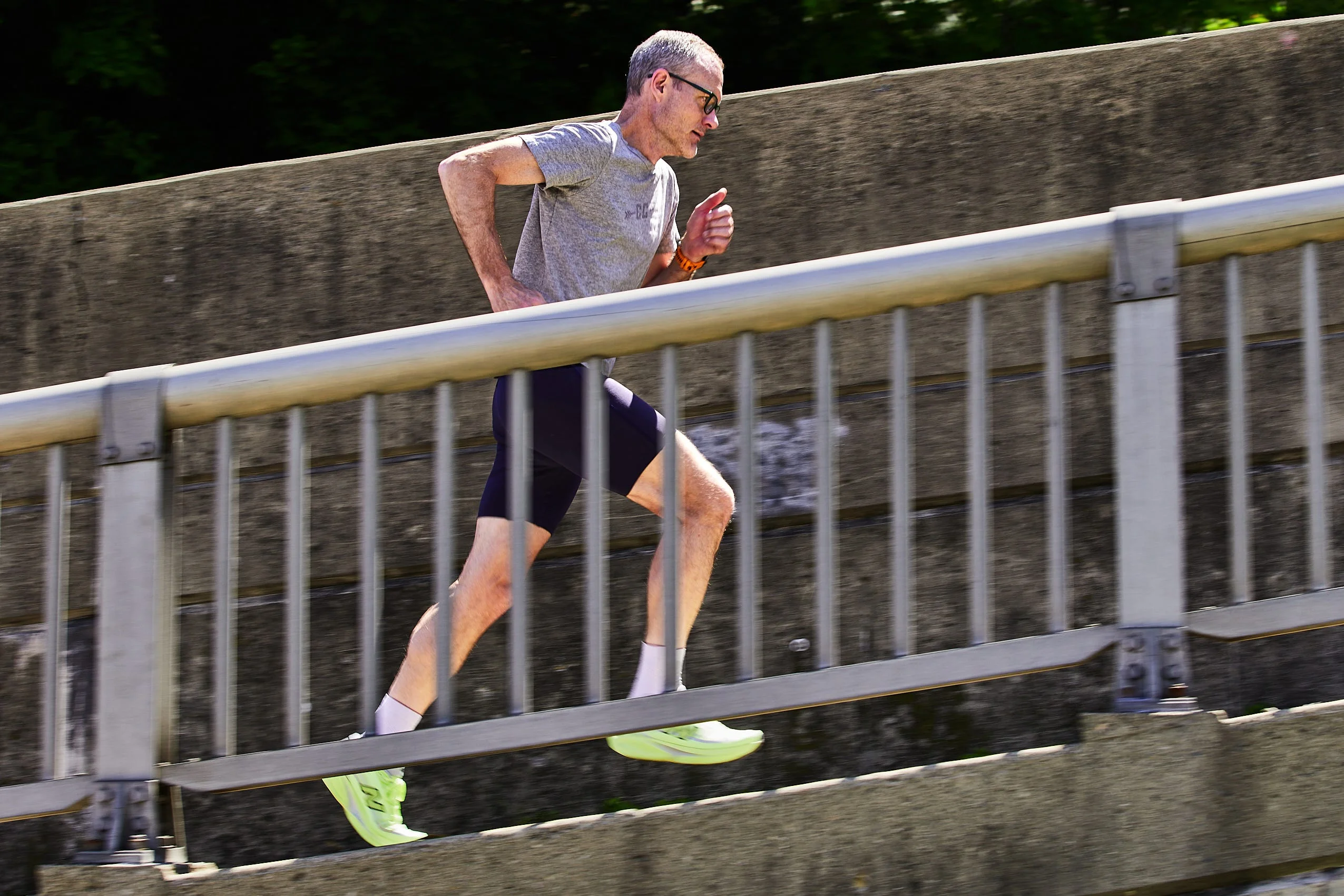 athlete running uphill on cement ramp athlete running uphill on cement ramp